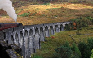 Bahn in Schottland über Bruecke fahrend